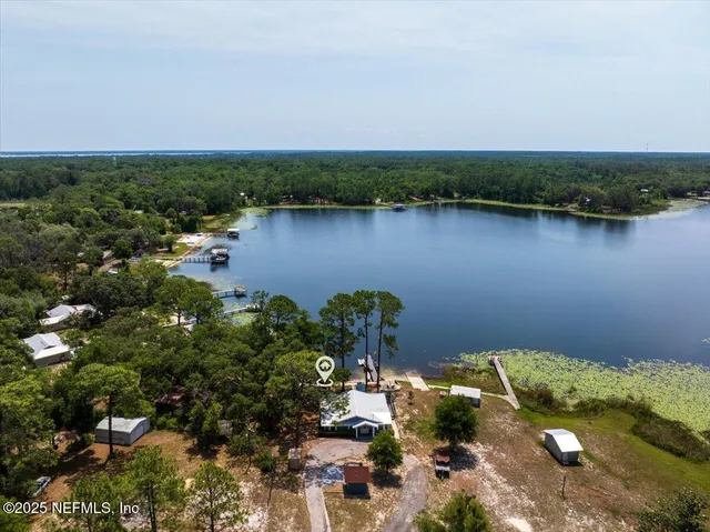 an aerial view of a houses with a lake view