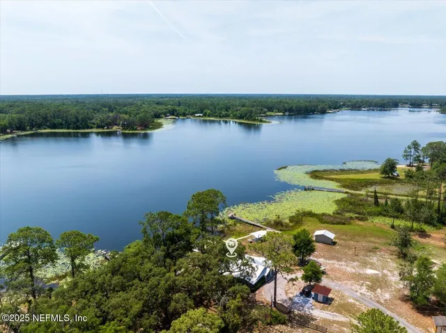 an aerial view of a houses with a lake view