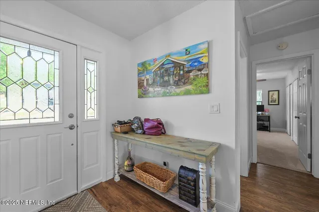 a view of an entryway with wooden floor