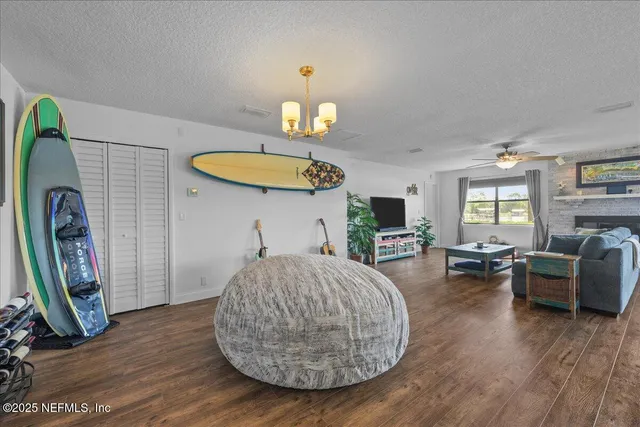 a living room with furniture a fireplace and a chandelier