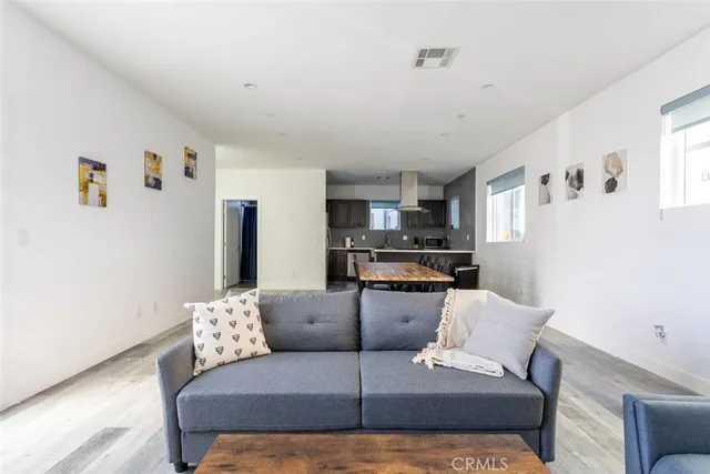 a living room with furniture and kitchen view