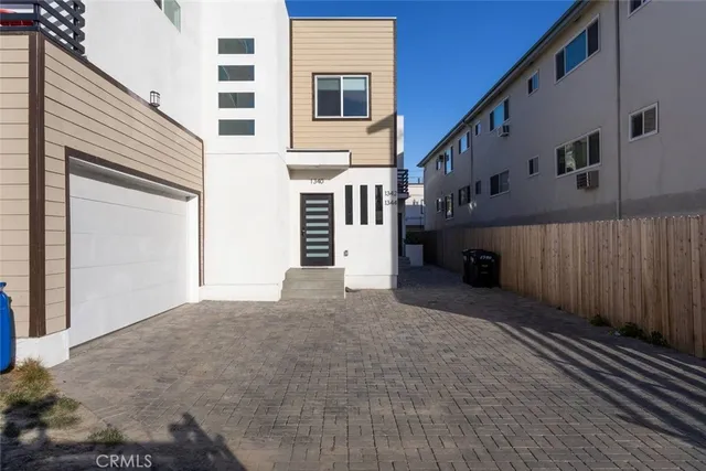 a view of a house with a wooden fence