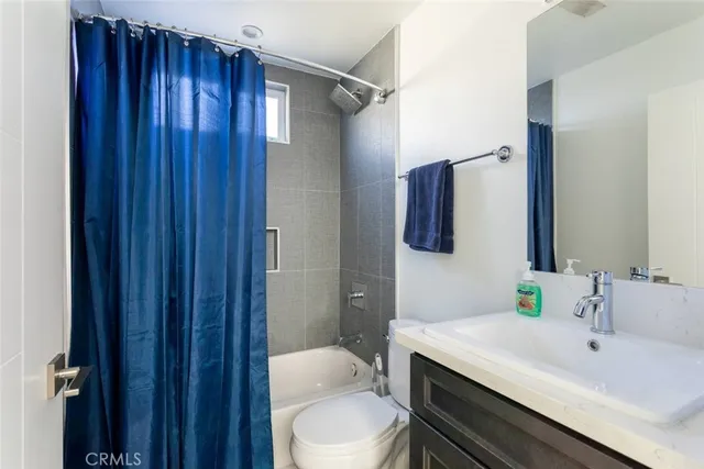 a bathroom with a sink vanity mirror and toilet