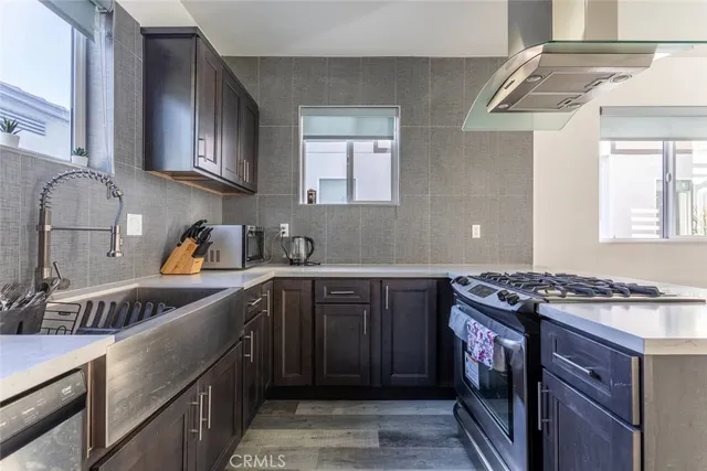 a kitchen with stainless steel appliances granite countertop a sink stove and cabinets
