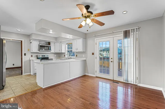 a kitchen with stainless steel appliances granite countertop a refrigerator a stove a sink dishwasher and a microwave oven with cabinets