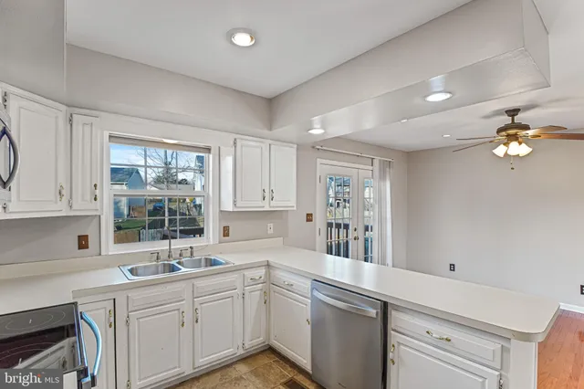 a kitchen with a sink cabinets and window