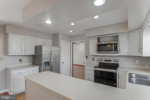 a kitchen with stainless steel appliances a refrigerator stove and microwave