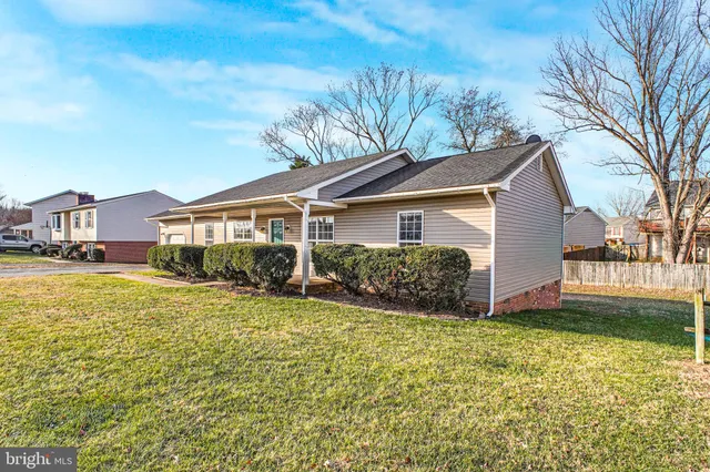 a front view of a house with yard and green space