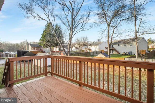 a view of balcony with wooden floor and fence