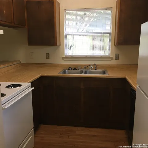 a kitchen with a sink and a window