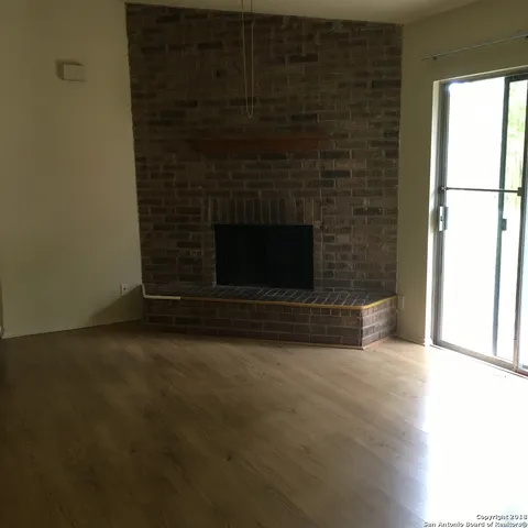 a view of empty room with a fireplace
