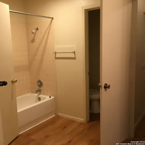 a bathroom with a bathtub and shower