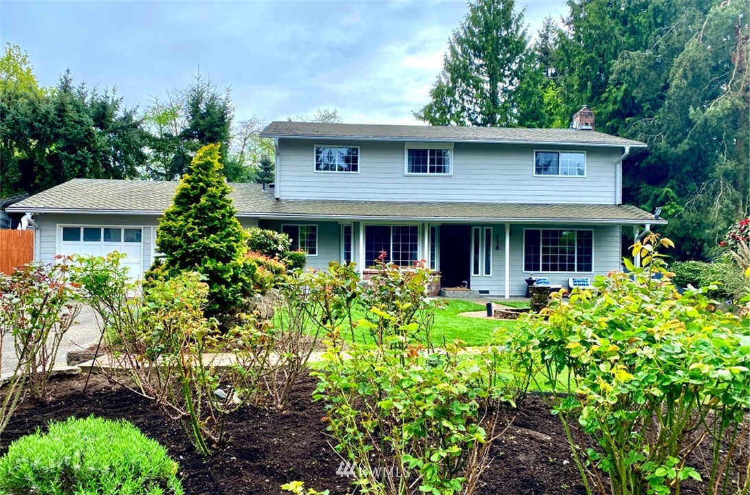 718 222nd Street Southwest Bothell, WA 98021 - Photo 1 of 22 a front view of a house with yard and green space