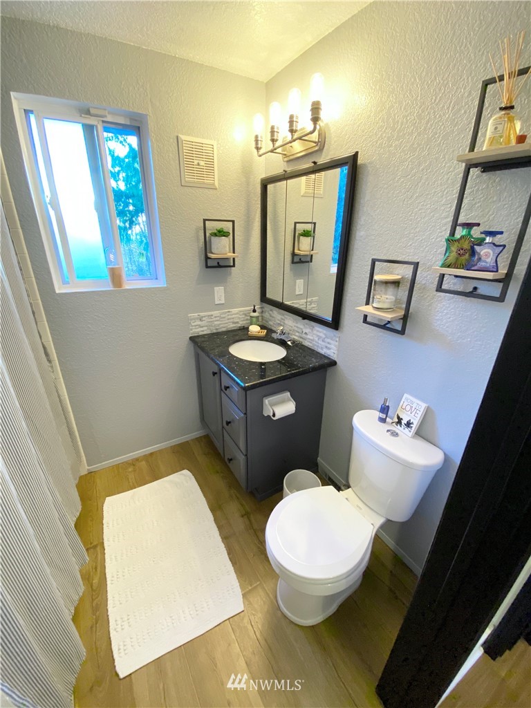 718 222nd Street Southwest Bothell, WA 98021 - Photo 14 of 22 a bathroom with a sink mirror vanity and toilet