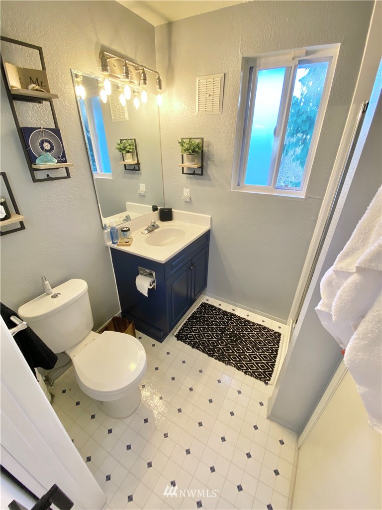 718 222nd Street Southwest Bothell, WA 98021 - Photo 15 of 22 a bathroom with a sink a toilet a mirror and shower