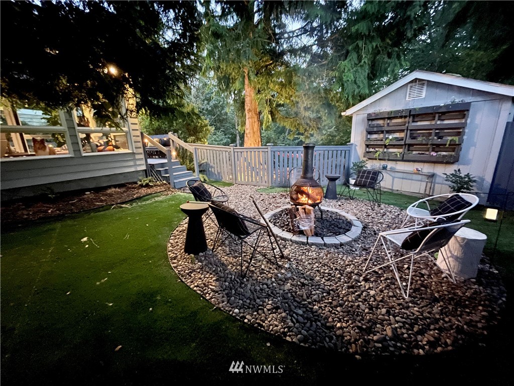 718 222nd Street Southwest Bothell, WA 98021 - Photo 18 of 22 a backyard of a house with barbeque oven and outdoor seating