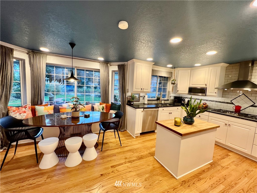 718 222nd Street Southwest Bothell, WA 98021 - Photo 6 of 22 a kitchen with a stove kitchen island dining table and chairs