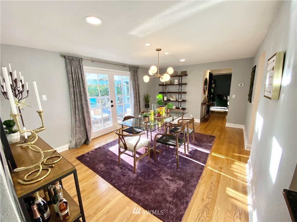 718 222nd Street Southwest Bothell, WA 98021 - Photo 8 of 22 a living room with furniture a chandelier and a dining table