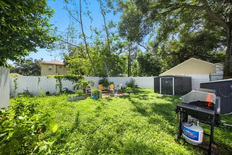 a backyard of a house with table and chairs