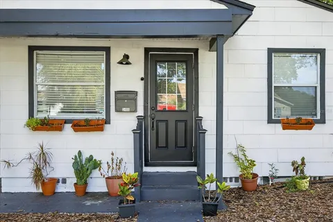 a view of front door of house with potted plant