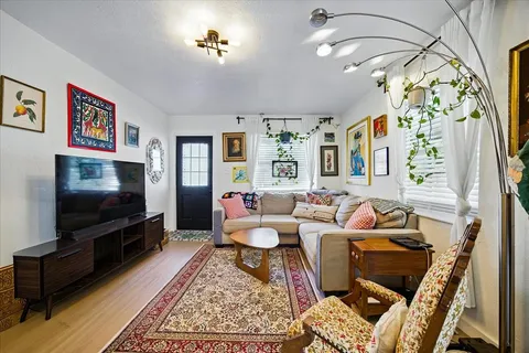 a living room with furniture and a flat screen tv