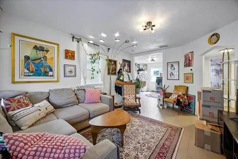 a living room with furniture and wooden floor
