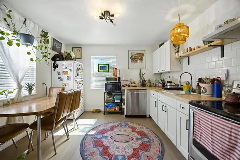 a kitchen with refrigerator and window