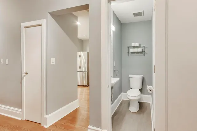 a bathroom with a toilet sink and mirror