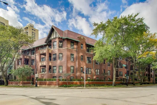 a view of a tall building next to a road