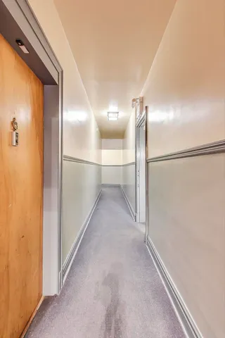 a view of hallway with wooden floor