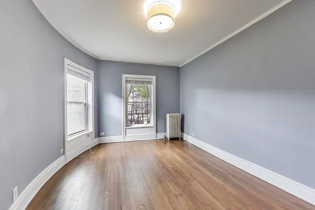 a view of room with wooden floor