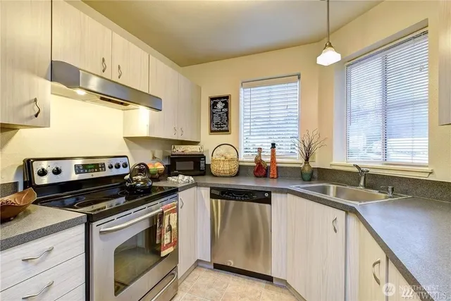 a kitchen with a sink stove and cabinets