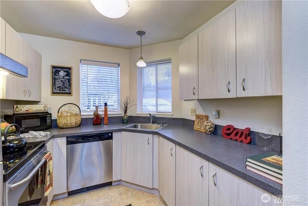 5300 Harbour Pointe Boulevard, Unit 304C Mukilteo, WA 98275 - Photo 12 of 19 a kitchen with granite countertop a sink cabinets and window