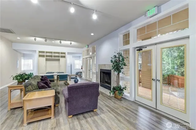 a living room with furniture a fireplace and a potted plant