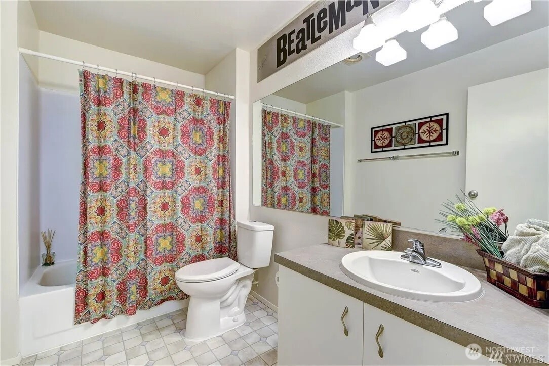 5300 Harbour Pointe Boulevard, Unit 304C Mukilteo, WA 98275 - Photo 8 of 19 a bathroom with a sink a toilet and a mirror