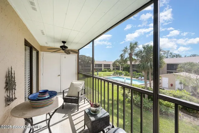 a view of a porch with furniture and garden