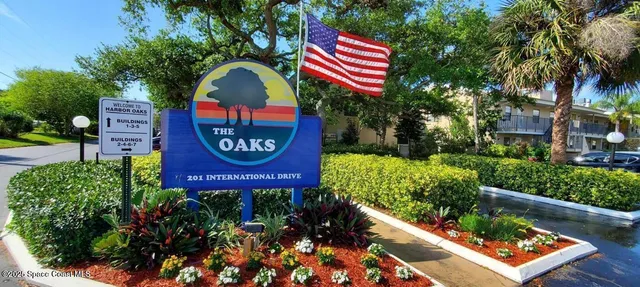 a view of a bench in a yard with potted plants