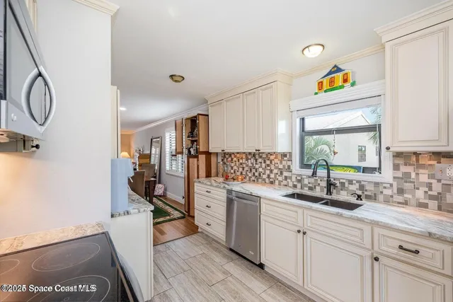 a kitchen with cabinets a sink and appliances