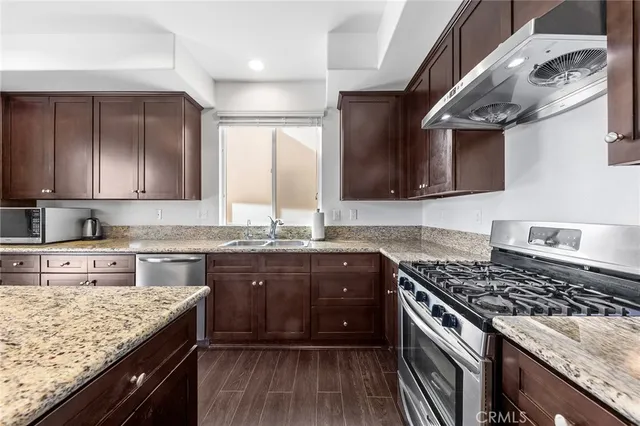 a kitchen with a stove sink and cabinets