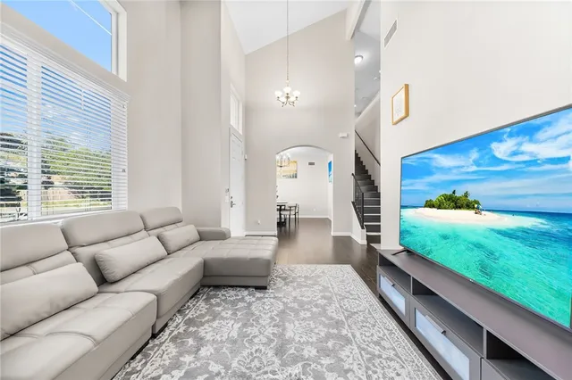 a living room with patio furniture with a rug