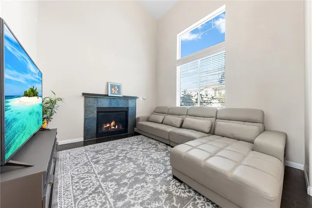a living room with furniture a window and a fireplace