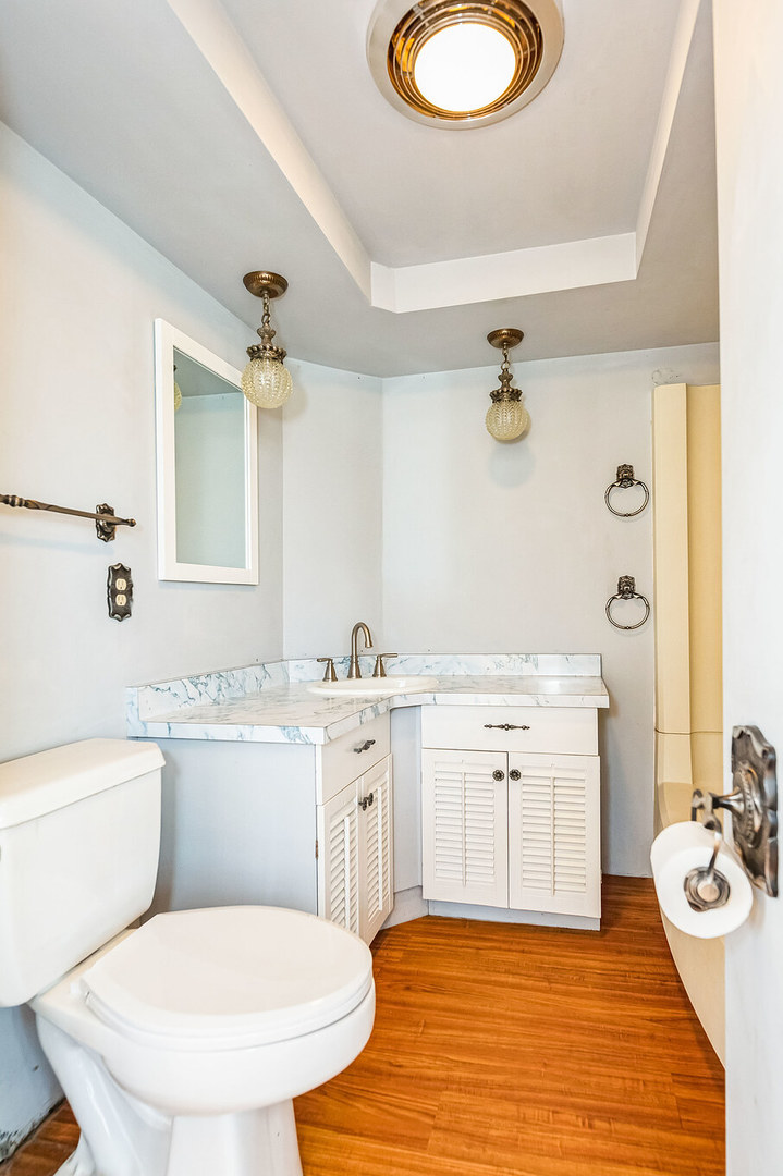 710 North 7th Street Rochelle, IL 61068 - Photo 18 of 32 a bathroom with a granite countertop sink toilet a mirror and bathtub