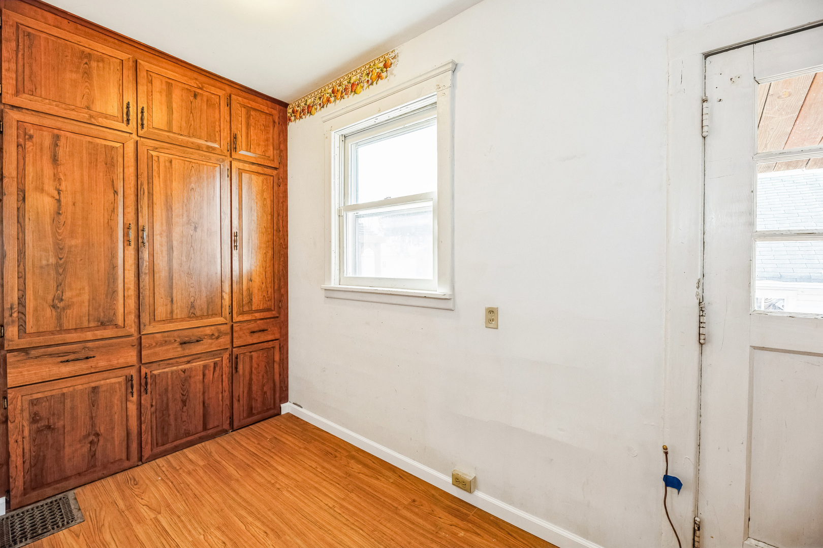 710 North 7th Street Rochelle, IL 61068 - Photo 9 of 32 a view of a room with wooden floor and cabinet