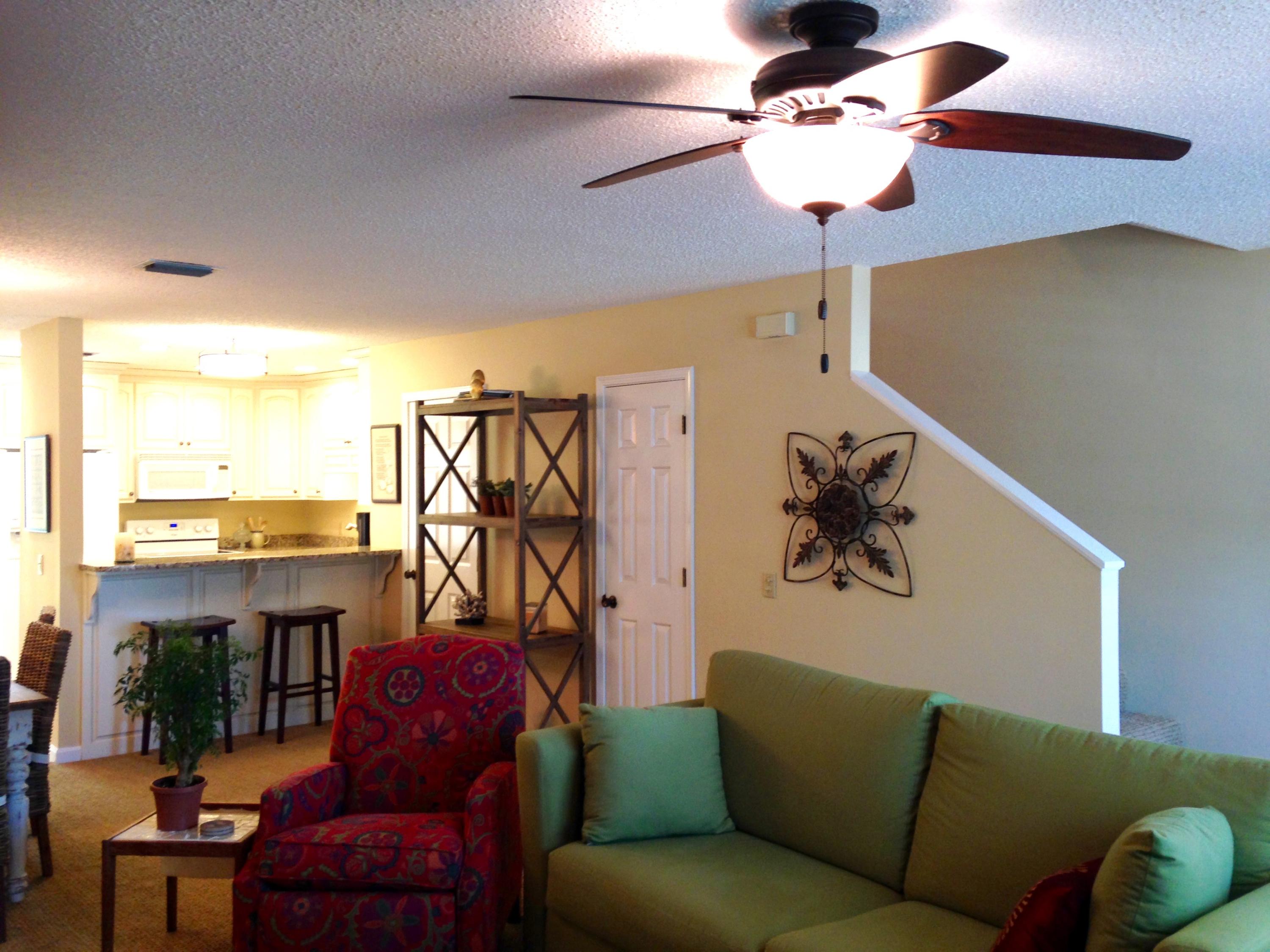241 Ellis Road, Unit 6 Miramar Beach, FL 32550 - Photo 30 of 30 a living room with furniture a chandelier and a window