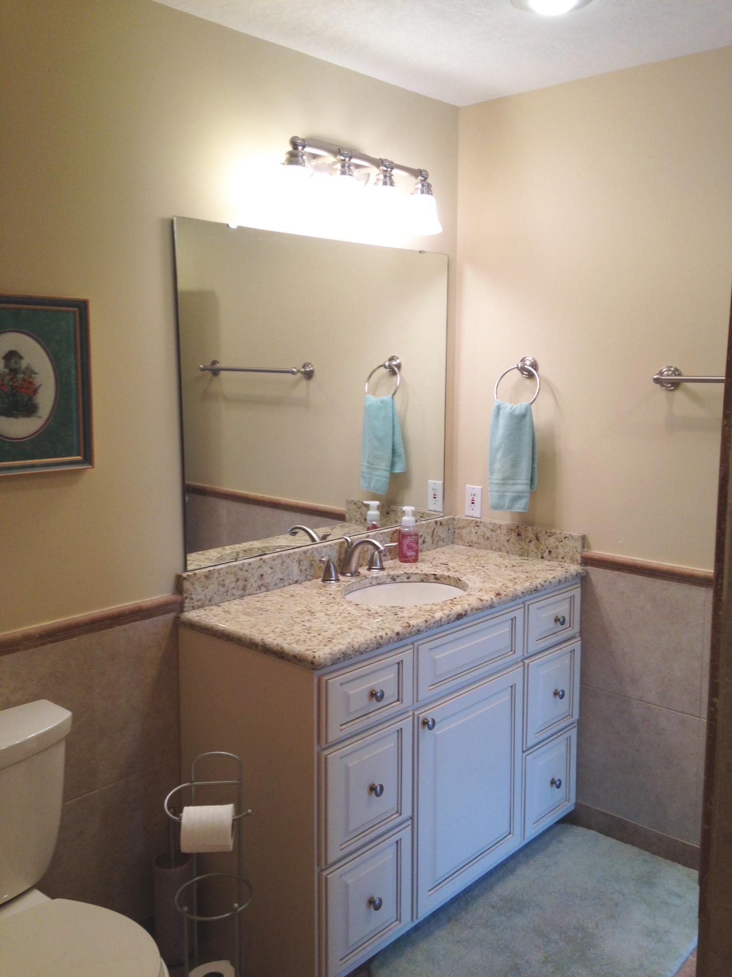 241 Ellis Road, Unit 6 Miramar Beach, FL 32550 - Photo 21 of 30 a bathroom with a granite countertop sink a toilet and a mirror