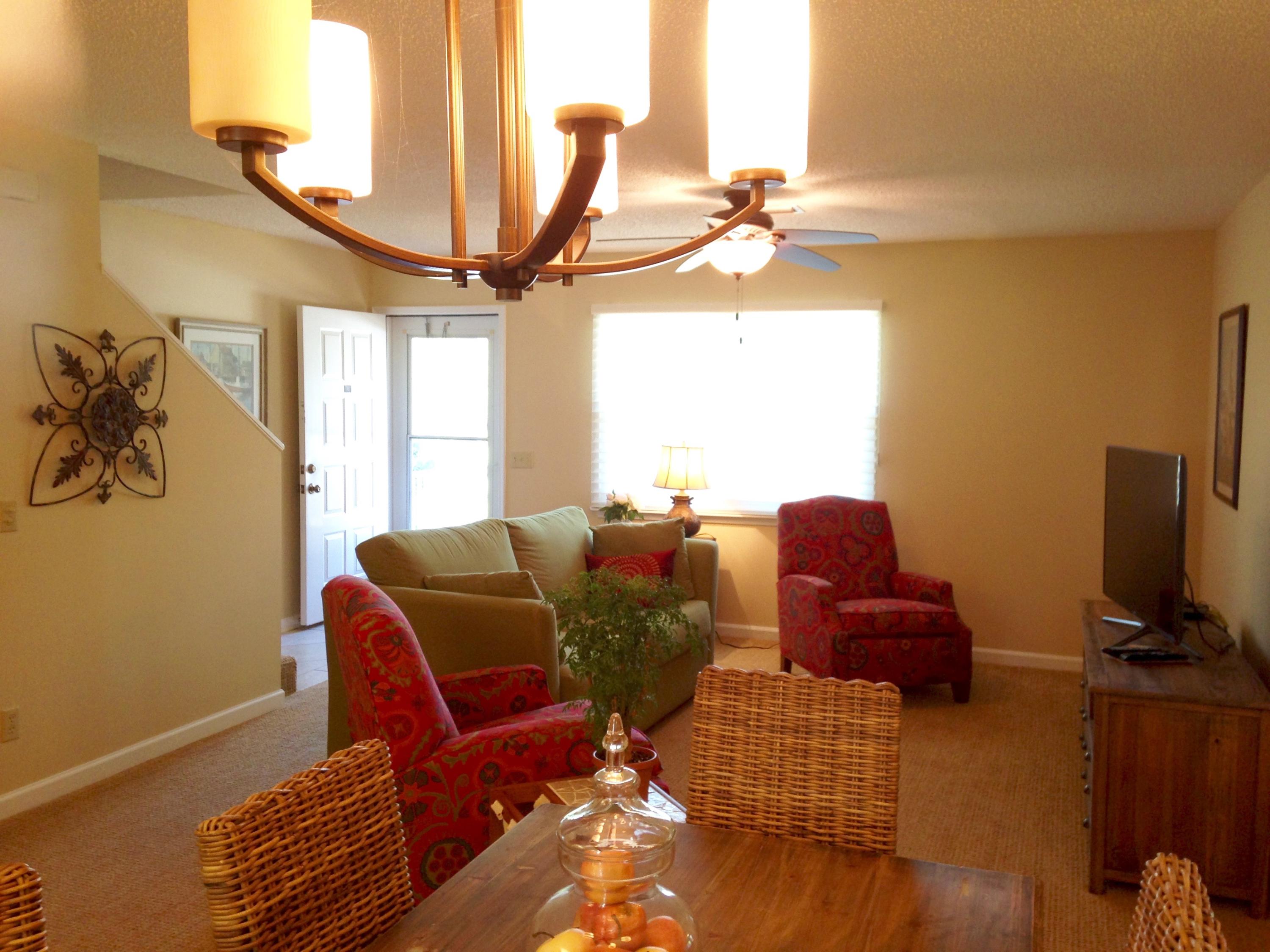 241 Ellis Road, Unit 6 Miramar Beach, FL 32550 - Photo 4 of 30 a living room with furniture a flat screen tv and a window