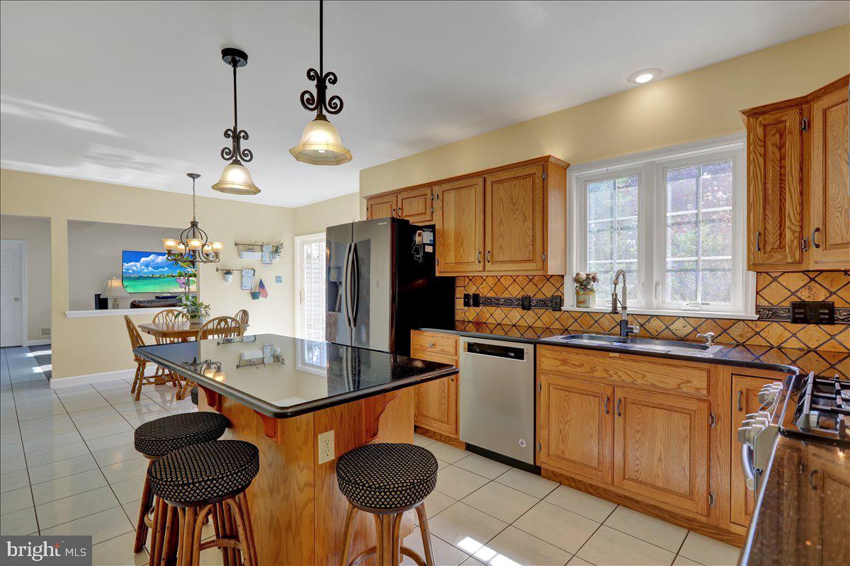 29 Colorado Avenue Sinking Spring, PA 19608 - Photo 5 of 40 a kitchen with stainless steel appliances a sink a stove a dining table and chairs