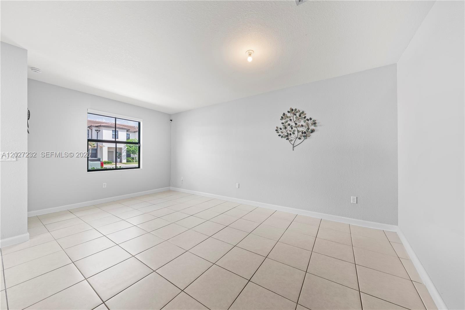 23489 Southwest 127th Place Homestead, FL 33032 - Photo 5 of 24 an empty room with windows
