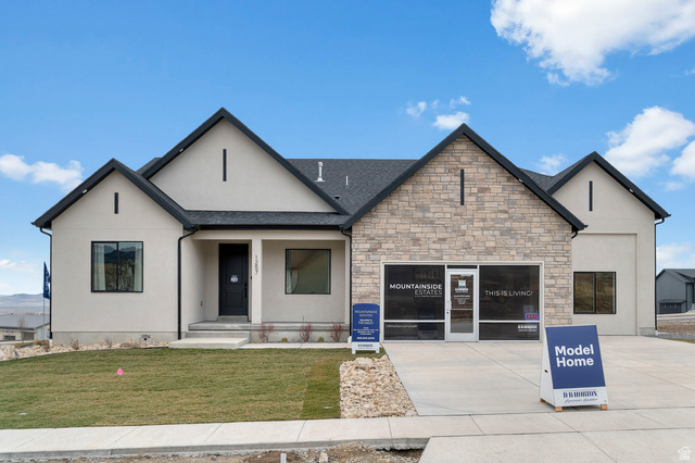 1238 East Talmage Lane, Unit 33 Logan, UT 84341 - Photo 1 of 1 View of front facade featuring a front yard, stucco siding, a porch, and stone siding