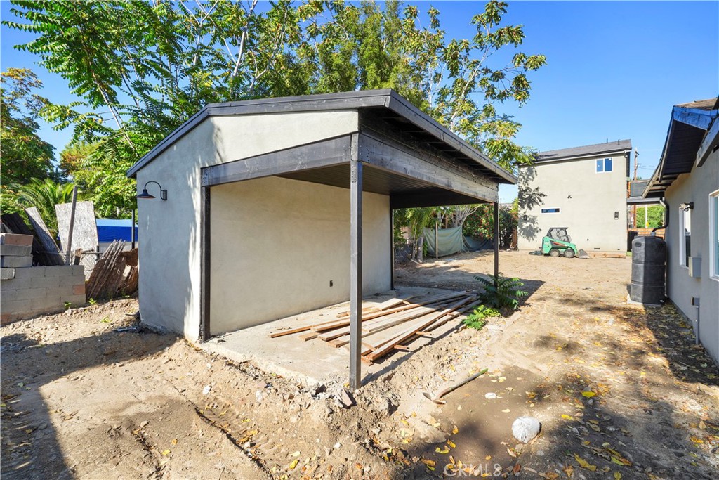 11531 Dronfield Avenue Pacoima, CA 91331 - Photo 6 of 12 a backyard of a house with large tree and wooden fence
